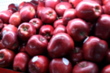 Blur photo Pile of maroon colored apples at the fruit market