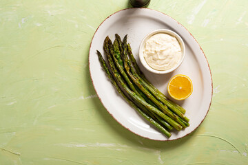 Overhead view of spring green roasted asparagus healthy food on green surface