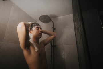 A moment of relaxation captured as a person bathes in a shower, showcasing a serene bathroom setting.