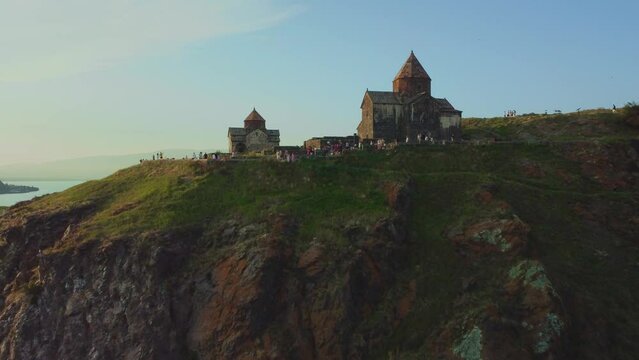 Drone shot of Sevanavank church with people in the surrounding areas.