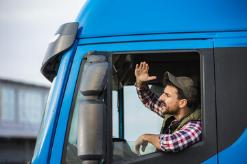 An angry truck driver is driving a truck and is annoyed with people who disturb the traffic