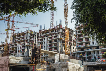 Building cranes on construction site in Tel Aviv city, Israel - obrazy, fototapety, plakaty