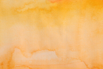 Ink watercolor hand drawn flow stain painting blot on wet paper texture background. Orange, Yellow color.