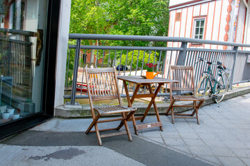 Tables with chairs in cafe outside near the river in summer.