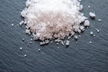 Salt crystals for cooking the food on a black natural background. .