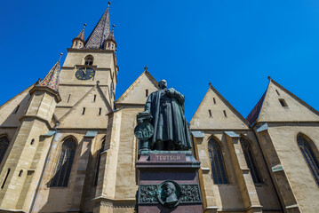 Fototapeta na wymiar Monument of Bishop Georg Daniel Teutsch in front of Lutheran Cathedral of St Mary in Old Town of Sibiu, Romania