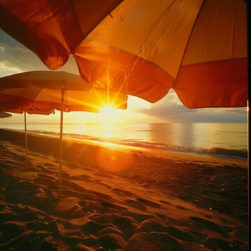 Sun rays cut through beach umbrellas at sunset sandy beach