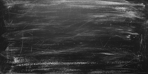 School blackboard texture. Black stone or slate textured background. Black chalk board texture background. Chalkboard, blackboard, school board surface with scratches and chalk traces. Wide banner.