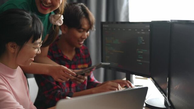 Slow motion back end software developer engineer for computer programming working together on debugging writing computing code, solving complex algorithms display on monitor in office. Burgeoning