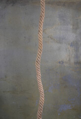 nautical rope hanging on a concrete wall - 771781322