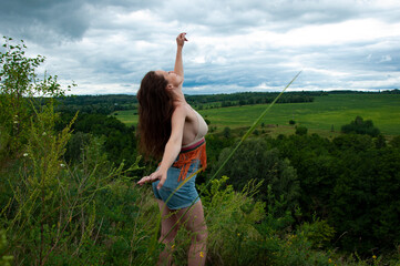 Woman in windy valley. Woman in the mountain valley. Landscape of summer nature. Travel girl hiking...