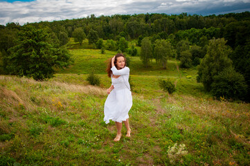 Woman in windy valley. Woman walk in mountain valley. Landscape of summer nature. Travel girl...
