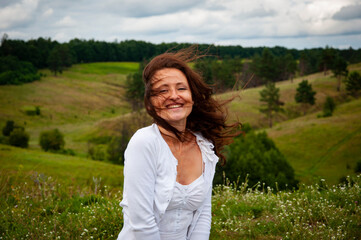 Woman in the mountain valley. Landscape of summer nature. Beautiful girl at nature valley outdoor. Freedom lifestyle. Carpathians mountain girl. Woman in windy valley. Wind of happiness