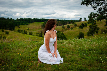 Beautiful girl at nature valley outdoor. Freedom lifestyle. Carpathians mountain girl. Woman in windy valley. Woman in the mountain valley. Landscape of summer nature. Picturesque view