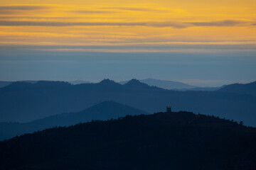 Forest lookout post silhouette during a winter sunset, Portugal.