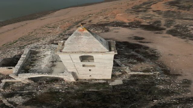 Vertical drone shot of church Sau swamp dike in Catalonia, Spain, drought in 2024 pantano de Sau. High quality 4k footage