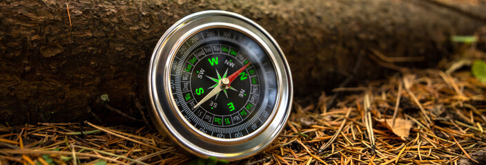 Traveler's compass on forest grass
