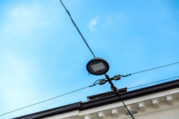 LED Street Lamp Suspended by Two Metal Cables Over a street in Treviso, Italy