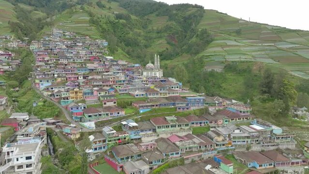 Aerial view of colorful houses on mountain slope in Central Java