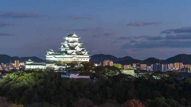 Dusk to night timelapse of Himeji Castle during fall season, Hyogo Prefecture, Japan, zoom out.