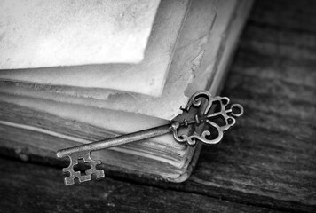 Retro Key And Opened Book On Wooden Table