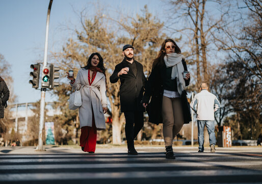 A vibrant image showcasing a mixed group of professionals crossing the street on a sunny winter day, highlighting the concept of team mobility and outdoor business activity.