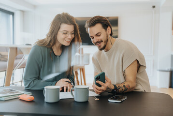 Young businesspeople collaborating in an office, discussing project details with confidence and persistence. Successful teamwork and cooperation in a positive workplace atmosphere.