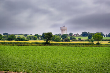 View of a water tower near Happisburgh in the middle of fields in spring, North Norfolk, England