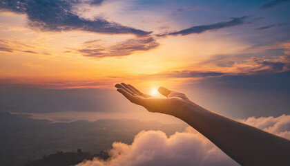 Hand reaching towards sunset sky, symbolizing hope, aspiration, and connection to nature. Perfect for inspirational concepts