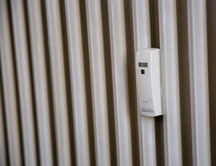 Close up of a wireless heat meter on white radiator. Heating of houses in the cold season