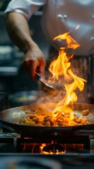 Close-up Professional chef hands cook food with fire in kitchen at restaurant