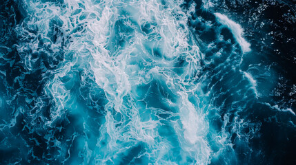 Naklejka premium Coast with waves as a background from top view. Blue water background from drone. Summer seascape from air