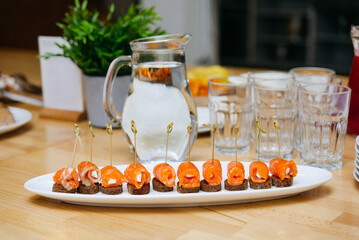 Smoked Salmon Appetizers on a Serving Plate. Elegant smoked salmon rolls with cream cheese served...
