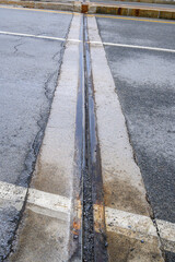 A metal expansion joint in a bridge. Expansion joints are used to allow for thermal expansion and contraction in bridges and other structures.