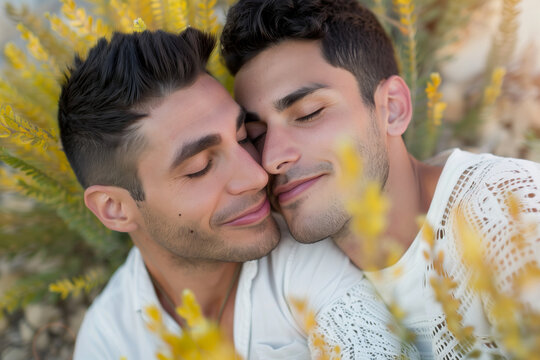 Gay love, tender couple of men in love on white flower grass for pride day