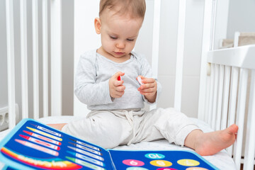 Baby Engaged with Montessori Busy Book in Crib