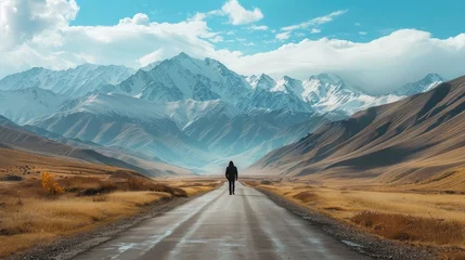 Fotobehang Traveler walking along the road to the mountains. © Khalif