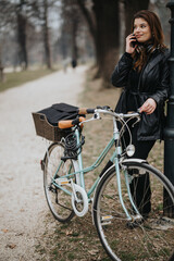 Fototapeta na wymiar Stylish and confident young woman standing with her vintage bicycle in a serene park setting.