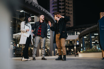 Three entrepreneurs engaged in a lively discussion during a casual meeting outdoors at night, embodying teamwork and collaboration.