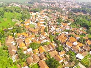 Fototapeta premium Cityscape of downtown district in Bandung city, Indonesia. View of the dense residential and highways in Downton. Social Issues. Drone Photography. Shot from a drone flying 100 meters