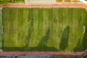 Aerial view of athletes playing soccer match on a grass field in Brazil