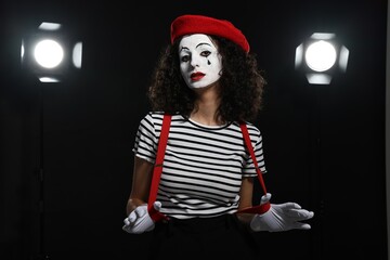 Young woman in mime costume performing on stage