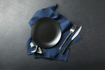 Stylish setting with elegant cutlery on grey textured table, top view