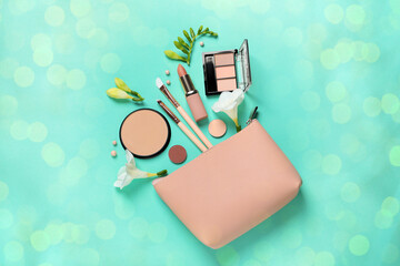 Different makeup products and beautiful freesia flowers on turquoise background, flat lay. Bokeh...
