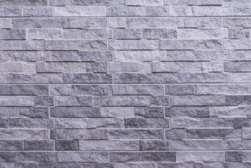 A wall of tiles that simulate gray stone bricks