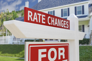  Rate Changes For Sale Real Estate Sign In Front Of New House.