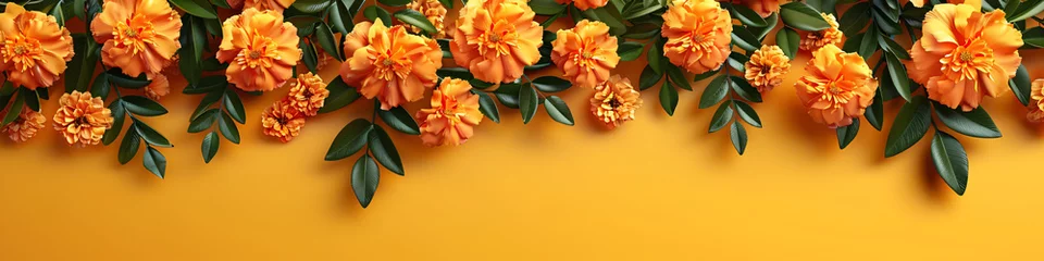 Fotobehang Orange and red marigold flowers on pastel yellow background. Chinese mid autumn festival. Toran Indian traditional decoration. Symbol of mexican holiday Day of dead. Happy Diwali © ratatosk