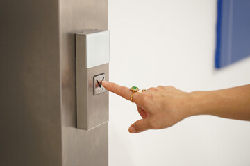 woman finger press on elevator button
