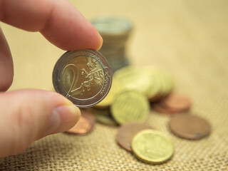 Hand Holding a Two Euro Coin