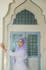 Portrait of young Asian woman wearing hijab posing.